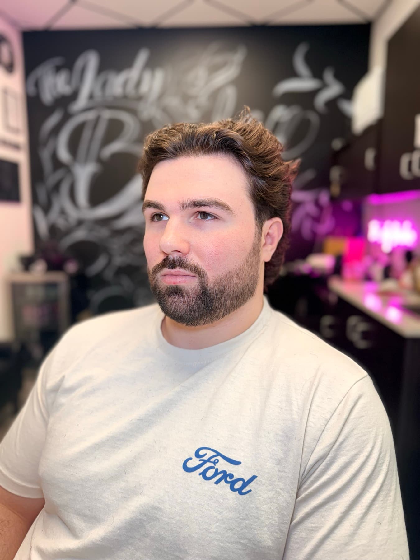 Medium wavy cut with a groomed beard